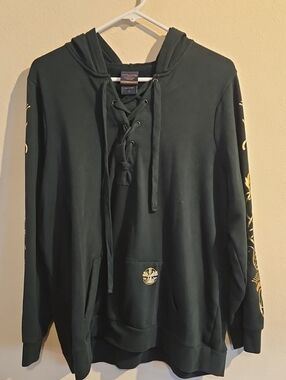 torrid Outlander Dark Green Lace-Up Hoodie with Gold Sleeve Prints